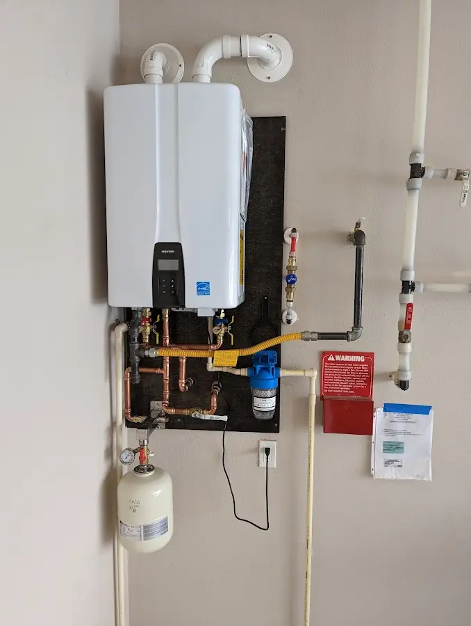 Professional plumber installing copper piping in a Parkland home